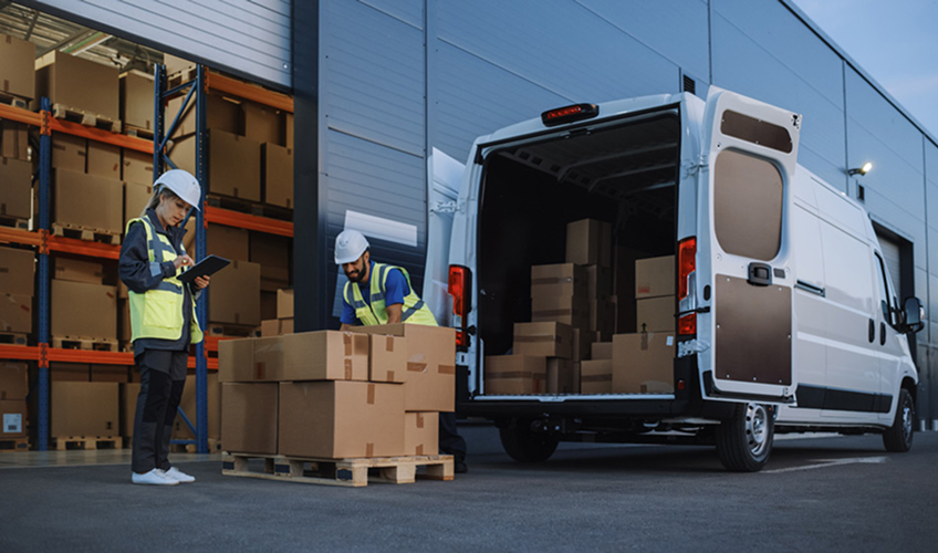 workers packing van with boxes